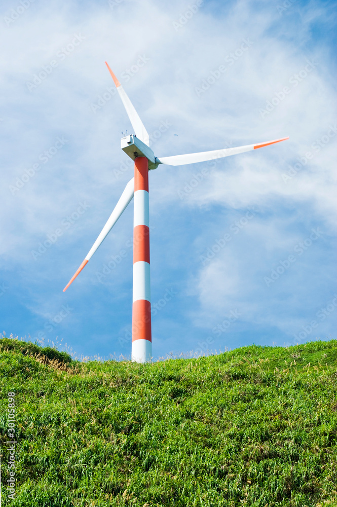 Wall mural wind turbine in green hill