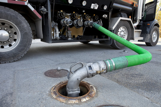 Fuel Delivery Tanker Truck Filling Up Storage Tank