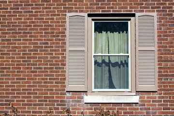 Fototapeta na wymiar Traditional window with wooden shutters.