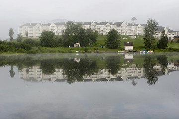 Fototapeta na wymiar Lakefront hotel early morning mist