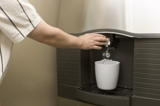Man filling bucket from Ice machine