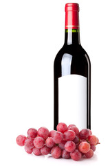 Red wine in bottle and grapes branch