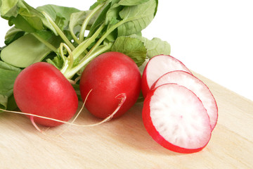 Fresh radishes on wooden board