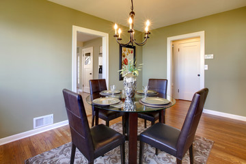 Classic dining room with leather chairs and glass table