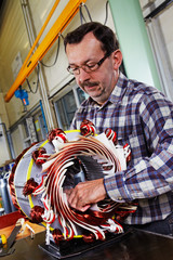 skilled industrial worker mounting big electric motor 04