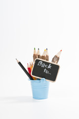 Bucket with full of color pencil and black board