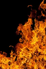 Wall murals Flame fire isolated over black background