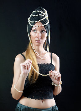 beautiful young woman in east turban, with pearl beads