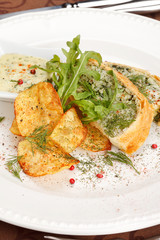 fish pie with sauce and potato chips