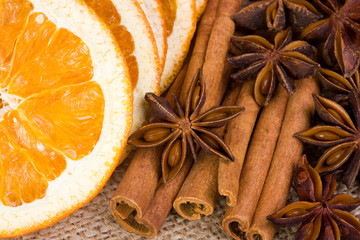 Sliced dried orange with cinnamon sticks and anise
