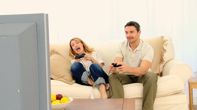 Pretty couple playing a video game