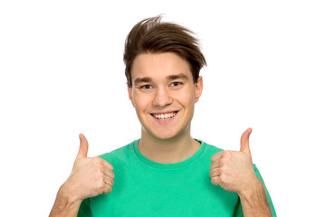 Casual young guy showing thumbs up
