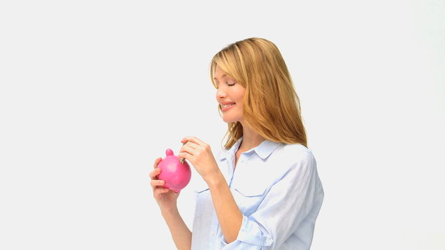 Blonde woman saving up money in a piggy bank