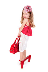 Funny little girl trying on her mother's shoes © netrun78