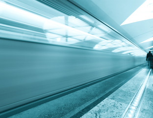 modern illuminated metro station with train motion