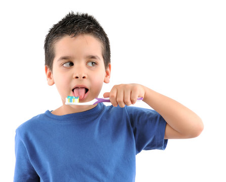 Cute boy brushing teeth isolated on white background.