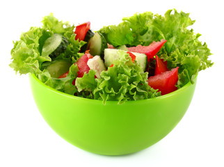 Green salad, cucumber and tomato in green plate isolated on whit