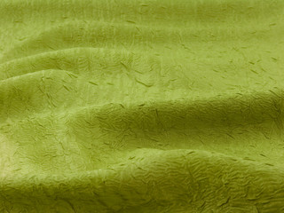 Зеленая ткань в волнах