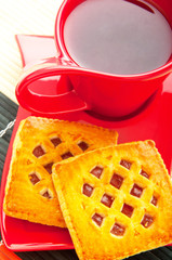 Cup of tea and fresh cookies on table