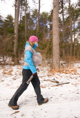 Young woman hike in forest with baby