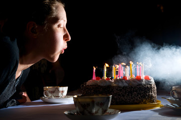 blowing out candles on cake - 30144626