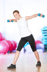 Fototapeta na wymiar Woman doing fitness exercise at sport gym
