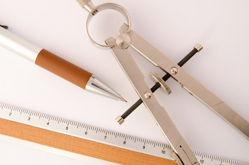 Drawing compass and ruler on white background