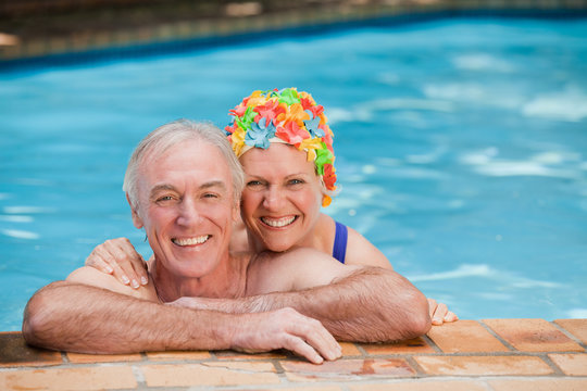 Happy mature couple in the swimming pool