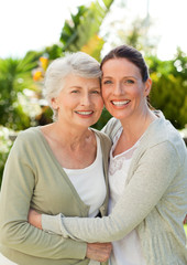 Obraz premium Mother with her daughter looking at the camera in the garden