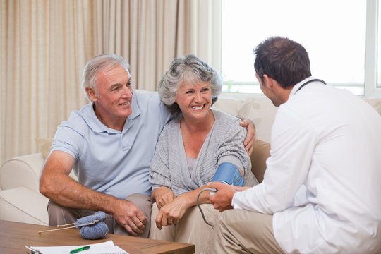 Doctor taking the blood pressure of his patient