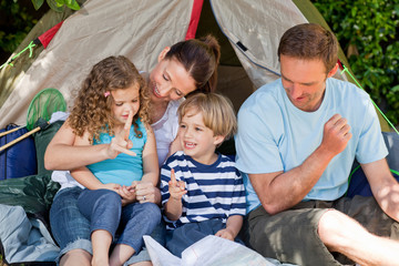 Adorable family camping in the garden