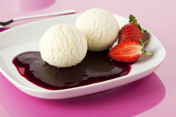 vanilla ice cream with berry sauce and strawberries