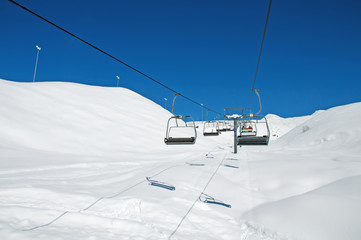 Ski lift chairs on bright winter day