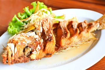 Fried snapper fish with sauce.