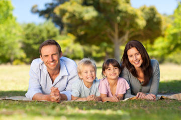 Family lying down in the park