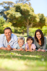 Family lying down in the park