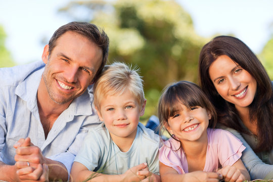 Family lying down in the park