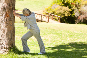 Mature woman doing her streches in the park