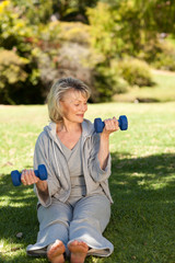 Retired woman doing her exercises in the park