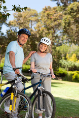 Fototapeta premium Elderly couple with their bikes