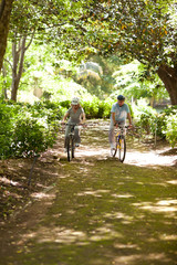 Fototapeta premium Elderly couple mountain biking outside