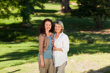 Fototapeta premium Mother with her daughter looking at the camera in the park