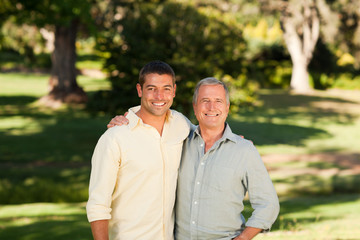 Obraz premium Father with his son looking at the camera in the park