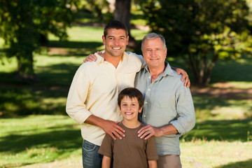 Fototapeta premium Radiant family looking at the camera in the park