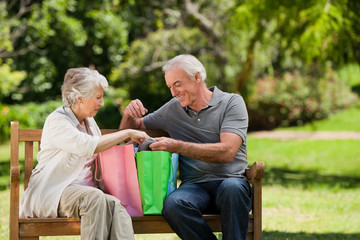 Retired couple with shopping bags