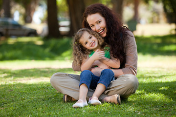 Mother with her daughter sitting in the garden