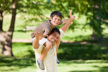 Handsome man giving son a piggyback