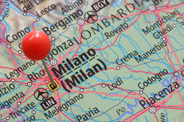 Close up of a pin on Milano or Milan on an atlas