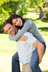 Man giving wife a piggyback