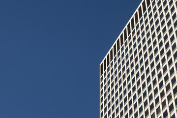 Detail of modern glass and steel building with blue sky